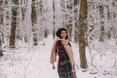 Rear view of woman standing in forest