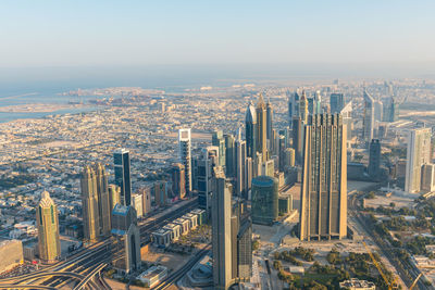 Aerial view of modern buildings in city against sky