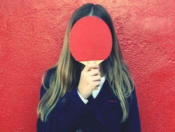 Teenage girl holding table tennis racket