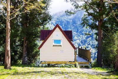 House by trees against sky