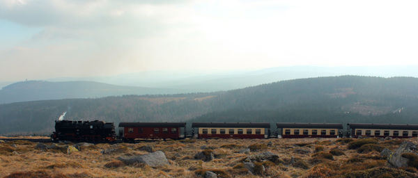 Built structure on land against mountains