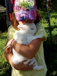 Midsection of woman holding hat