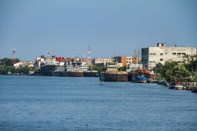 River by town against clear blue sky