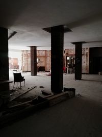 Empty chairs and table in abandoned building