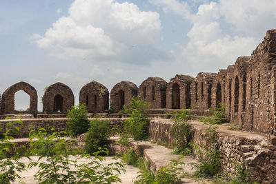 Top wall of rohtas fort  against cloudy sky