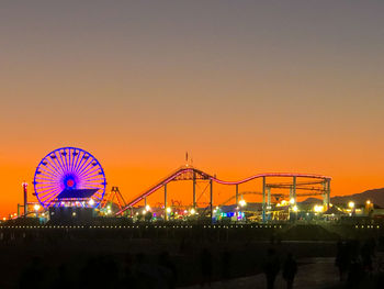 Illuminated ferris wheel at night