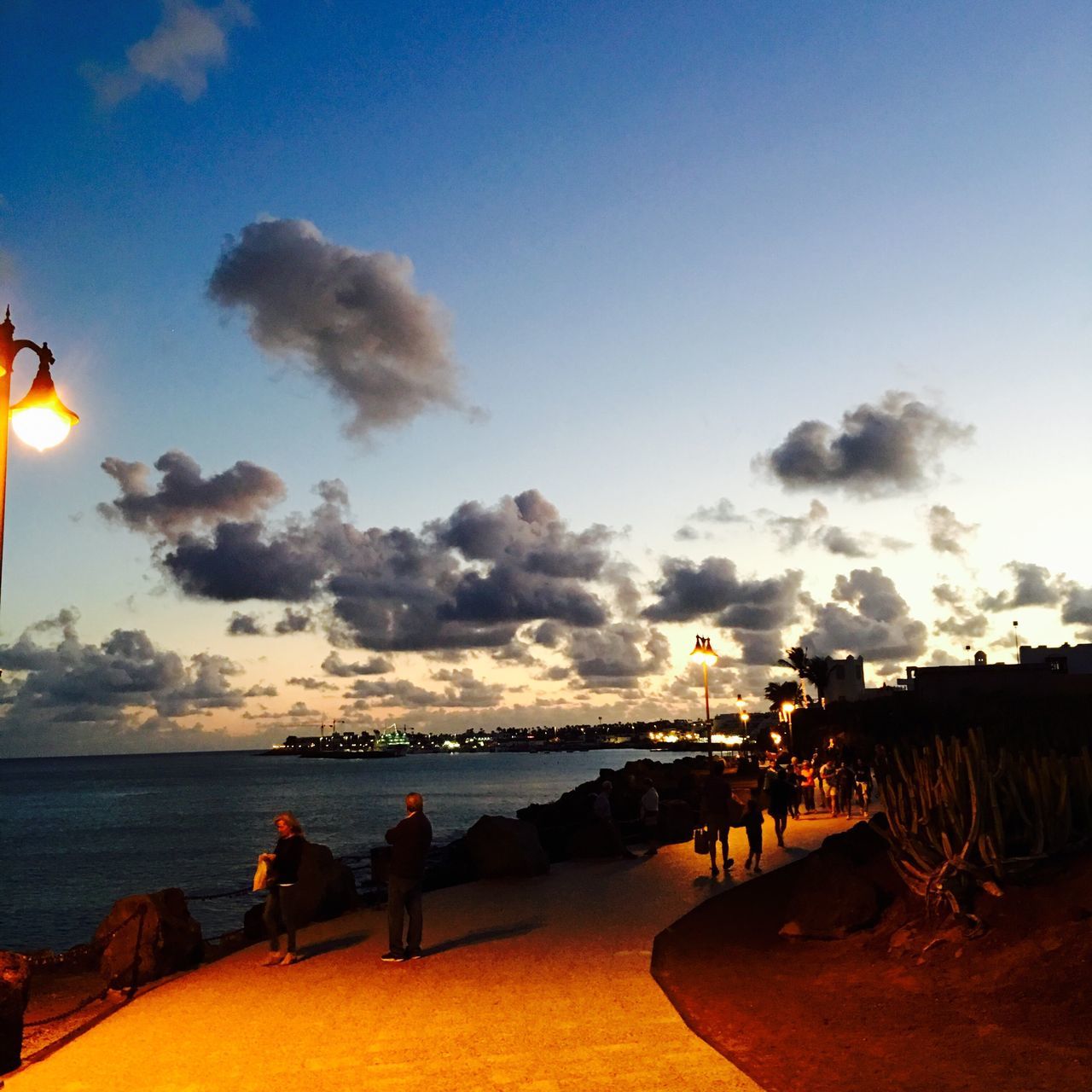 sea, water, sky, sunset, beach, scenics, tranquility, tranquil scene, beauty in nature, horizon over water, cloud - sky, nature, shore, idyllic, dusk, sand, incidental people, illuminated, transportation, outdoors