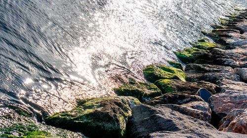 Low angle view of water flowing through rocks