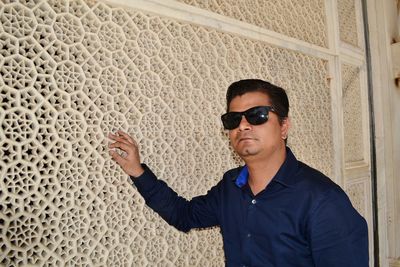 Portrait of man wearing sunglasses standing outdoors