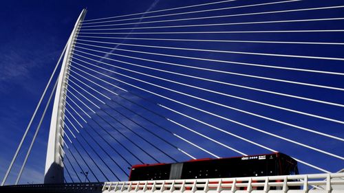 Low angle view of modern building against blue sky