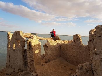 People on beach against sky