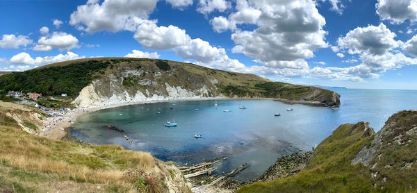 High angle view of sea and mountains against sky