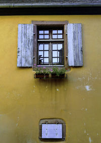 Low angle view of window on old building