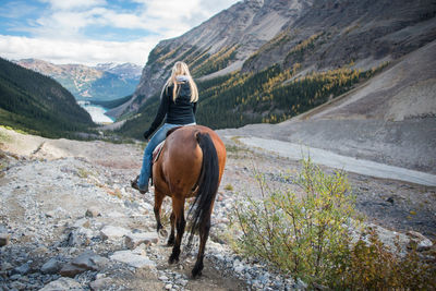 Rear view of horse riding