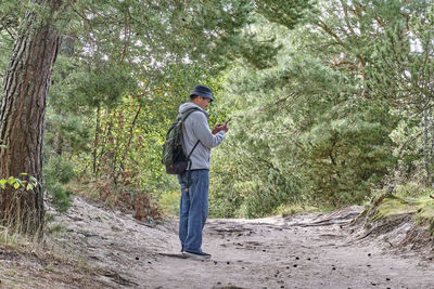 Rear view of man standing in forest