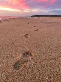 Scenic view of beach against sky during sunset