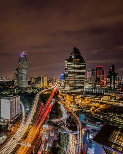 High angle view of illuminated cityscape against sky at night