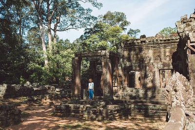 Mid adult woman standing outside ankor wat temple