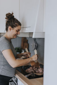 Pregnant woman in kitchen preparing food