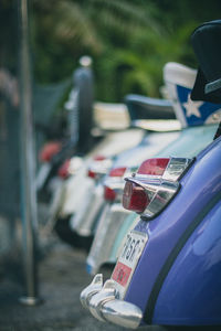 Close-up of tail lights of vintage cars in row