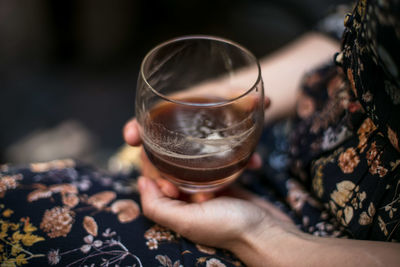 Midsection of woman holding alcohol glass