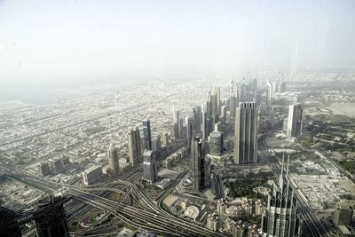 High angle view of modern buildings in city against sky