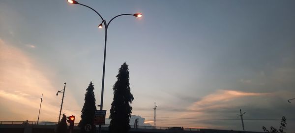 Low angle view of silhouette street against sky during sunset