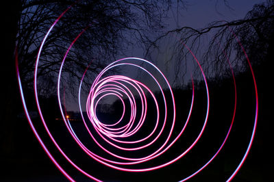 Close-up of light trails against sky at night