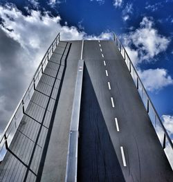 Low angle view of modern building against cloudy sky