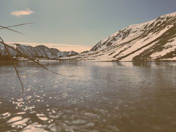 Scenic view of lake against sky during winter