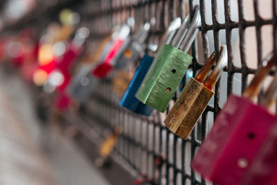 Close-up of padlocks hanging on railing