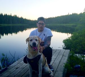 Portrait of man with dog in lake