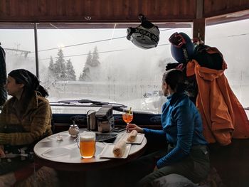 Young woman sitting on table during winter