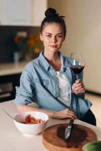 Portrait of young woman holding wineglass