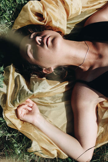 Young woman with scarf on field during sunny day