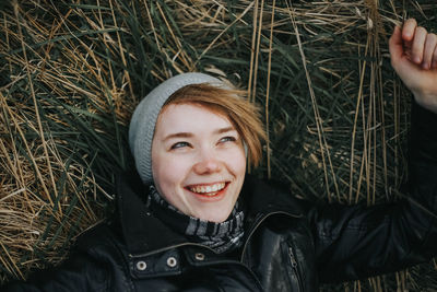 Portrait of smiling woman in lying in grass