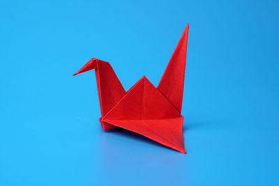 Close-up of paper flag against blue background