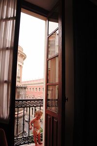 Boy looking through window