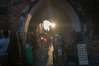 People on street amidst buildings in city