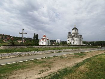 Church by building against sky