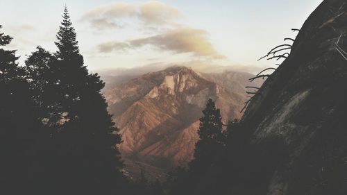 Scenic view of mountains against cloudy sky