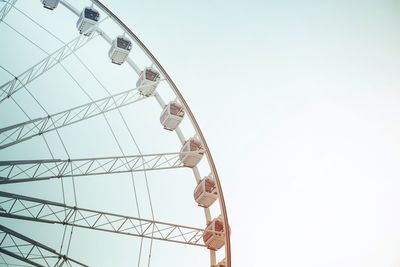 Low angle view of ferris wheel against clear sky