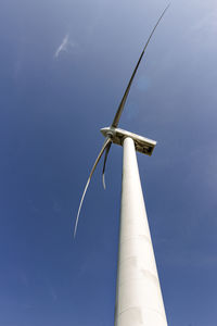 Low angle view of wind turbine against sky