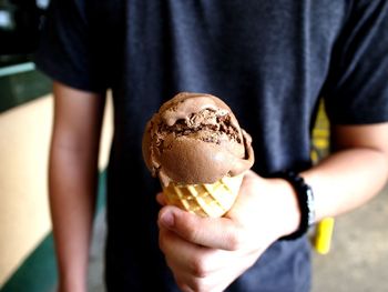 Midsection of man holding ice cream cone