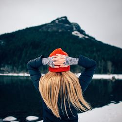 Rear view of woman standing against sky