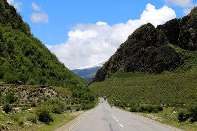 Road amidst mountains against sky 