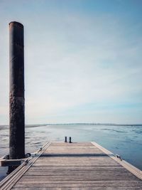 Pier over sea against sky