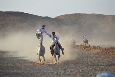People riding in desert