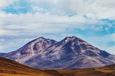 Mountain peak against cloudy sky