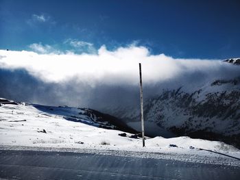 Scenic view of snow covered field against sky